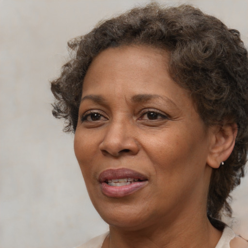 Joyful black adult female with short  brown hair and brown eyes
