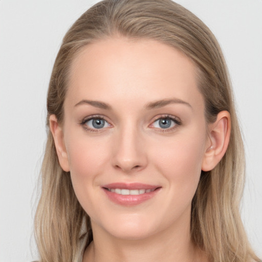 Joyful white young-adult female with long  brown hair and blue eyes