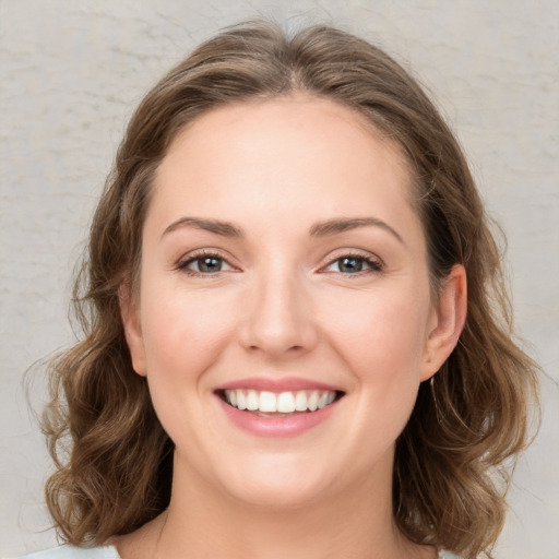 Joyful white young-adult female with medium  brown hair and green eyes