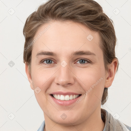 Joyful white young-adult female with short  brown hair and grey eyes