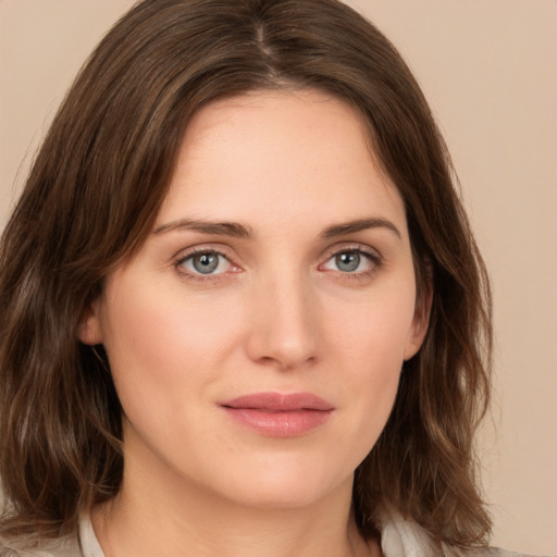 Joyful white young-adult female with medium  brown hair and green eyes