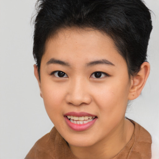 Joyful asian young-adult female with short  brown hair and brown eyes