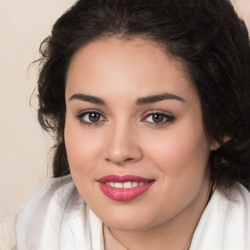 Joyful white young-adult female with long  brown hair and brown eyes