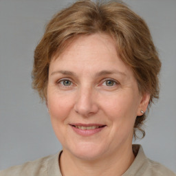 Joyful white adult female with medium  brown hair and blue eyes