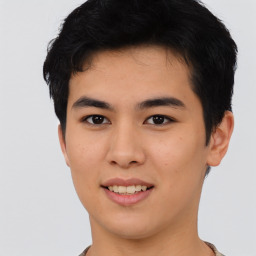 Joyful asian young-adult male with short  black hair and brown eyes