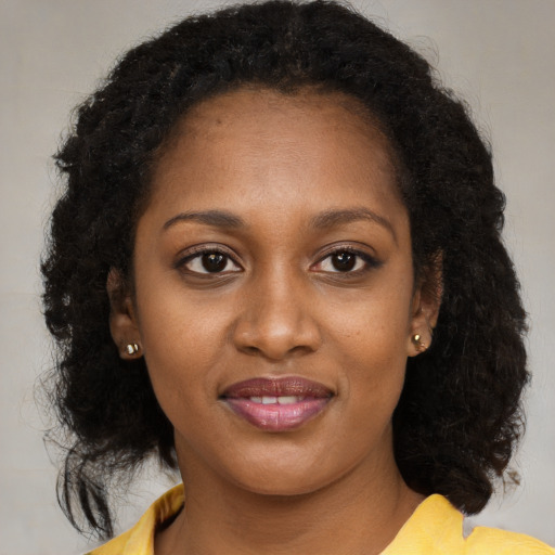 Joyful black young-adult female with medium  brown hair and brown eyes