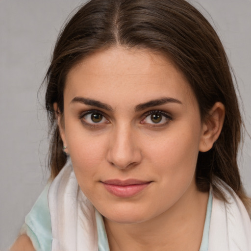 Joyful white young-adult female with medium  brown hair and brown eyes