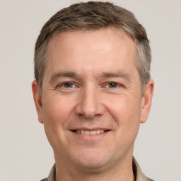 Joyful white adult male with short  brown hair and brown eyes