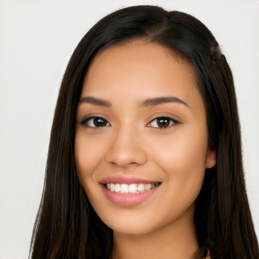 Joyful latino young-adult female with long  brown hair and brown eyes