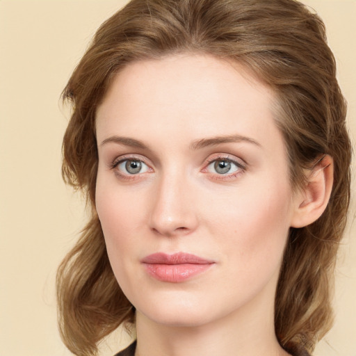 Joyful white young-adult female with medium  brown hair and green eyes