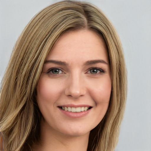 Joyful white young-adult female with long  brown hair and green eyes