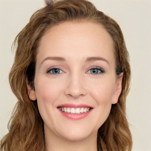 Joyful white young-adult female with long  brown hair and green eyes