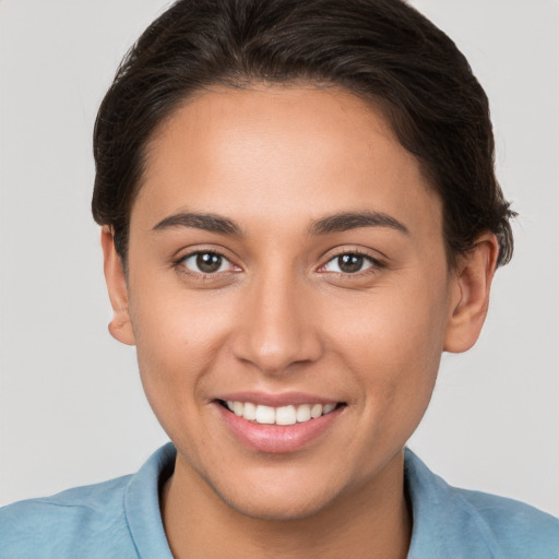 Joyful white young-adult female with short  brown hair and brown eyes