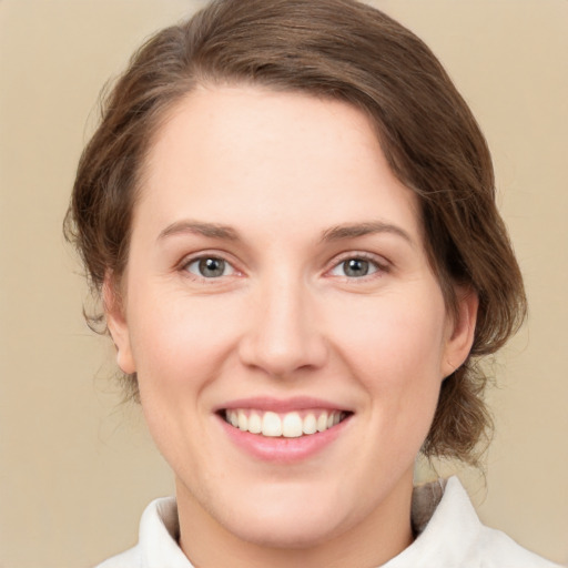 Joyful white young-adult female with medium  brown hair and green eyes