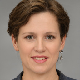 Joyful white adult female with medium  brown hair and grey eyes