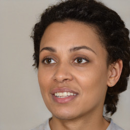 Joyful black young-adult female with medium  brown hair and brown eyes