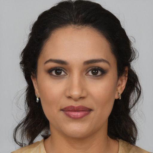 Joyful latino young-adult female with medium  brown hair and brown eyes