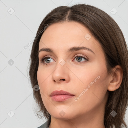 Neutral white young-adult female with long  brown hair and brown eyes