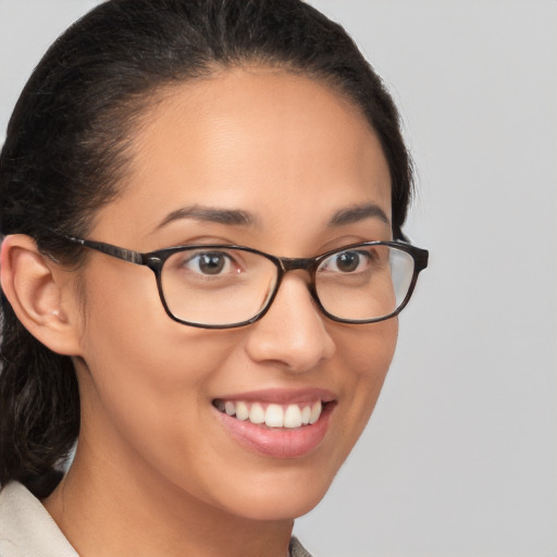 Joyful latino young-adult female with medium  brown hair and brown eyes