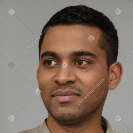 Joyful black young-adult male with short  black hair and brown eyes