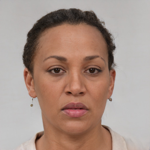 Joyful latino adult female with short  brown hair and brown eyes
