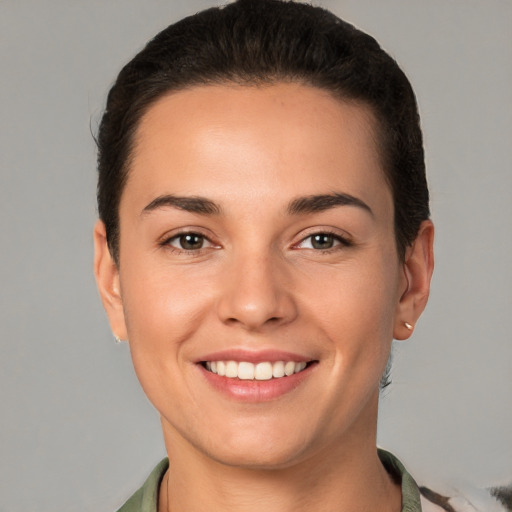 Joyful white young-adult female with short  brown hair and brown eyes