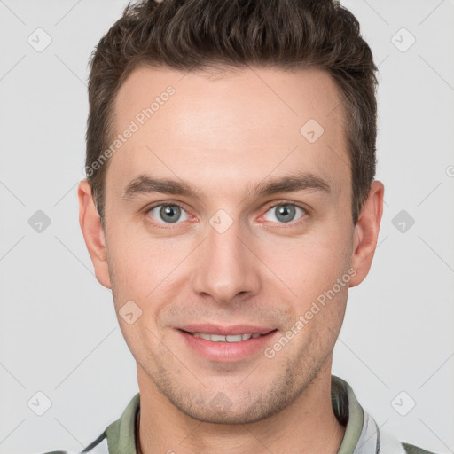 Joyful white young-adult male with short  brown hair and grey eyes