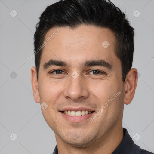 Joyful white young-adult male with short  brown hair and brown eyes