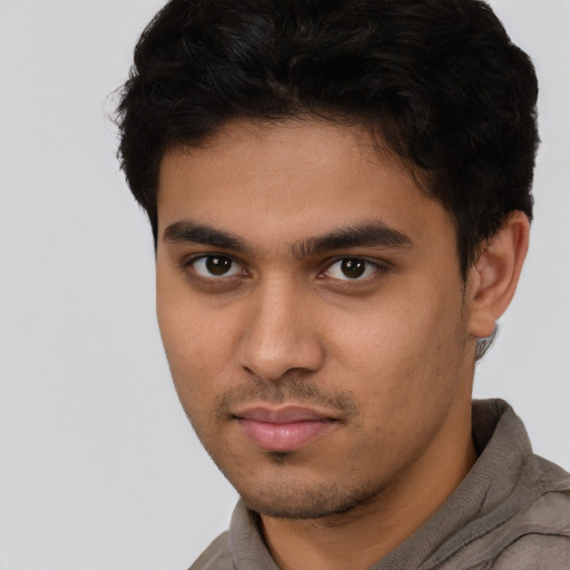 Neutral latino young-adult male with short  brown hair and brown eyes