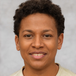 Joyful latino young-adult male with short  brown hair and brown eyes