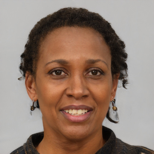Joyful black adult female with short  brown hair and brown eyes