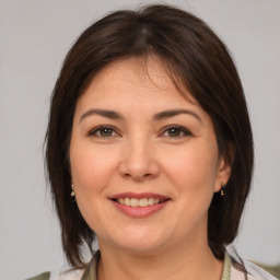 Joyful white adult female with medium  brown hair and brown eyes