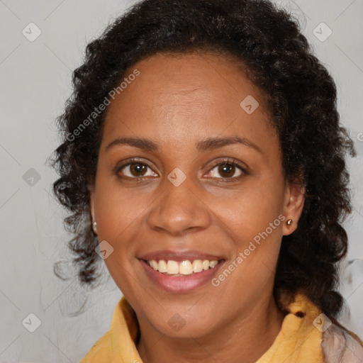 Joyful black young-adult female with long  brown hair and brown eyes