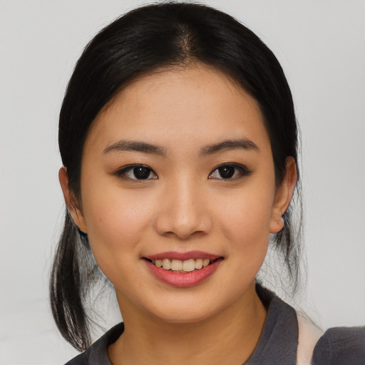 Joyful asian young-adult female with medium  black hair and brown eyes