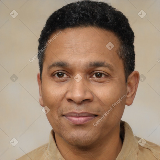 Joyful latino adult male with short  black hair and brown eyes