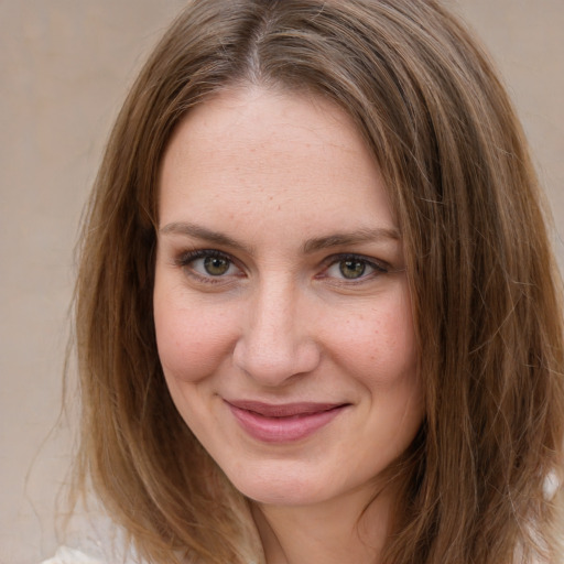 Joyful white young-adult female with medium  brown hair and green eyes