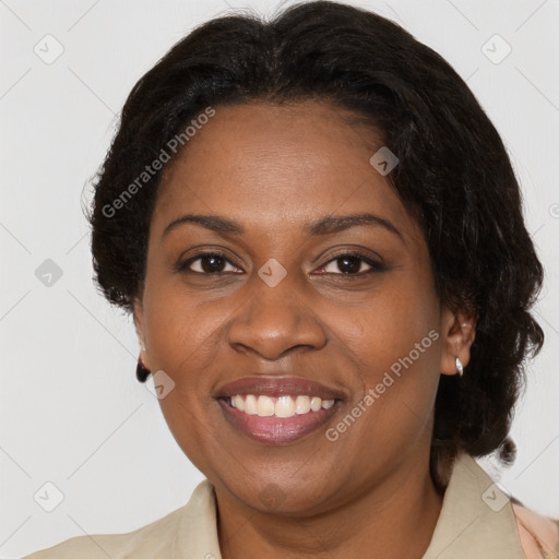 Joyful black adult female with medium  brown hair and brown eyes