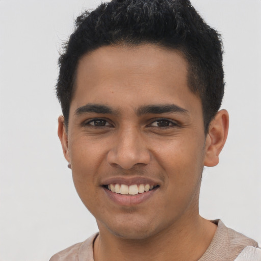 Joyful latino young-adult male with short  brown hair and brown eyes