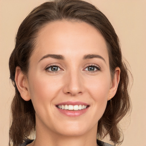 Joyful white young-adult female with medium  brown hair and brown eyes