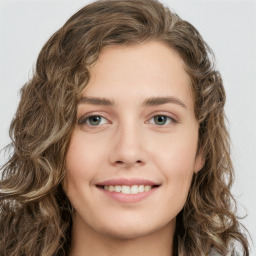 Joyful white young-adult female with long  brown hair and green eyes