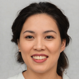 Joyful asian young-adult female with medium  brown hair and brown eyes