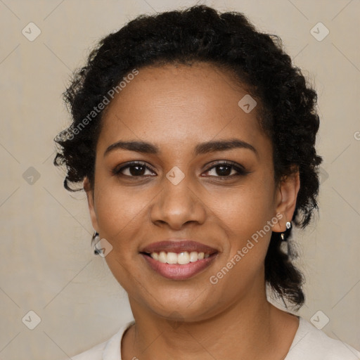 Joyful black young-adult female with short  brown hair and brown eyes