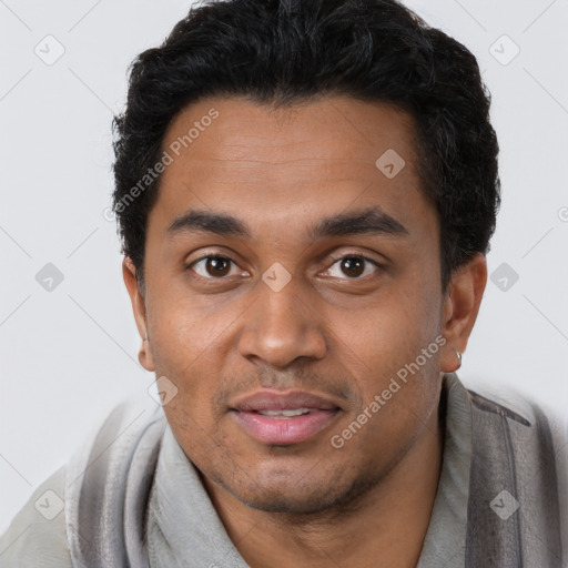 Joyful black young-adult male with short  black hair and brown eyes