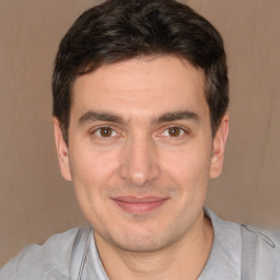 Joyful white adult male with short  brown hair and brown eyes