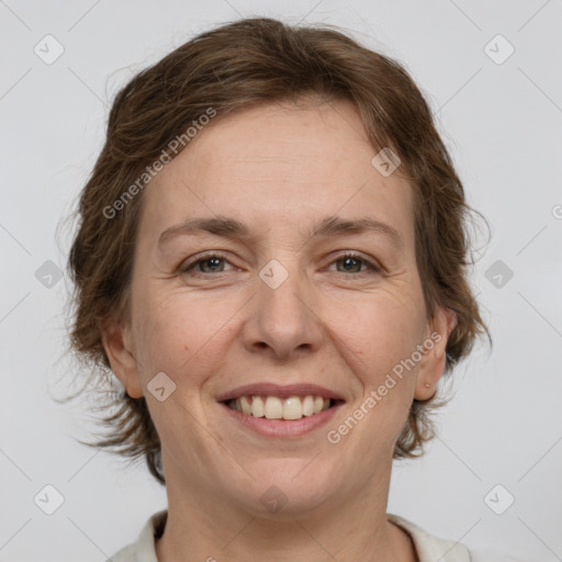 Joyful white adult female with medium  brown hair and grey eyes