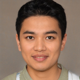 Joyful latino young-adult male with short  brown hair and brown eyes