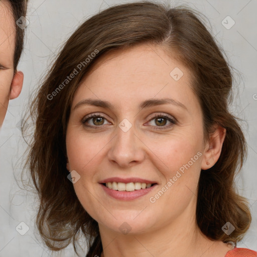 Joyful white young-adult female with long  brown hair and green eyes