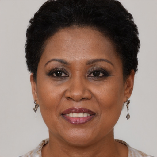Joyful black adult female with short  brown hair and brown eyes