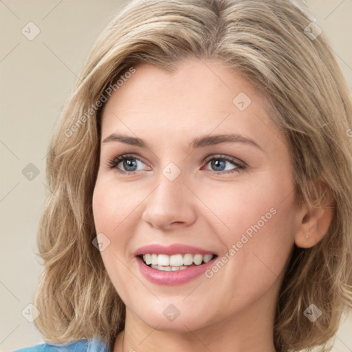 Joyful white young-adult female with medium  brown hair and green eyes