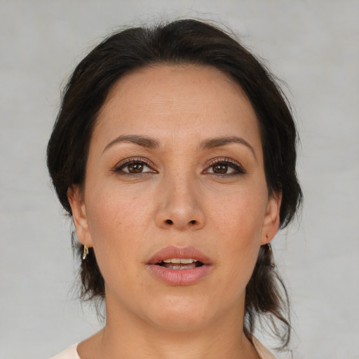 Joyful asian adult female with medium  brown hair and brown eyes